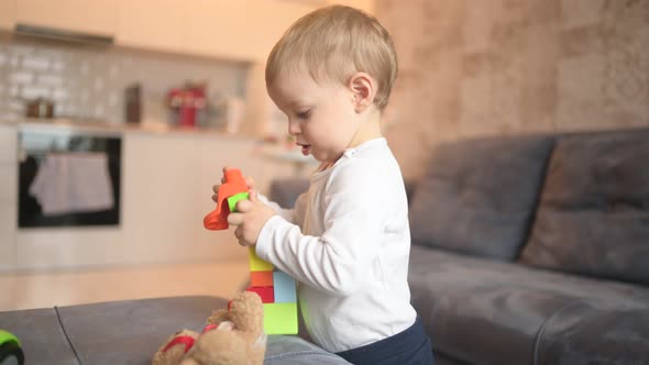 Little Happy Cute Baby Toddler Boy Blonde Playing with Constructor