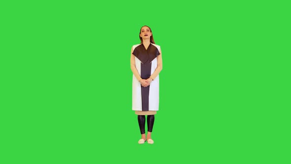 Android Girl Stands Straight Looking in Camera Saying Something on a Green Screen Chroma Key