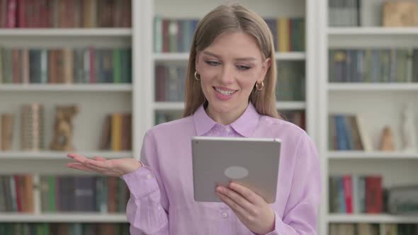 Portrait of Video Call on Tablet By Woman in Office alt