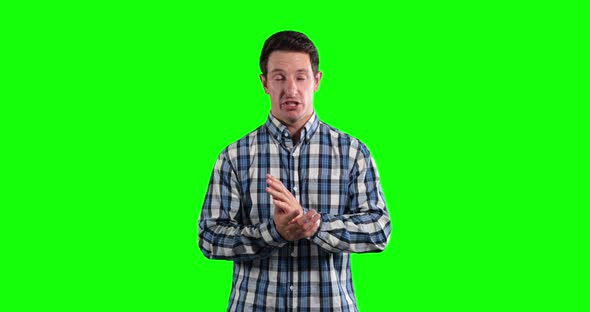 a Caucasian man talking in a green background