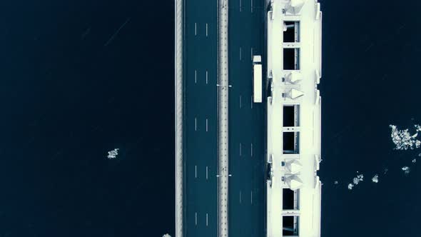 Amazing Aerial View Vertically Down the Highway Across the Bay in Snowfall. Drone Shoot. alt