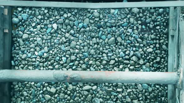 Top View of a Factory Conveyor with Crushed Minerals on It alt