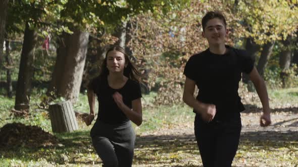 Children Are Playing in the Park. Happy Girl and Boy Are Running Around in the Park. alt