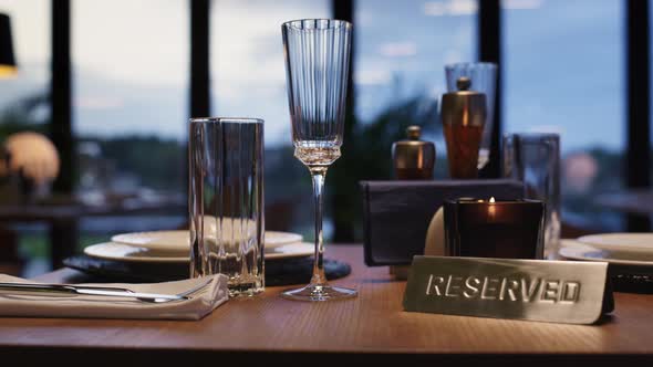 Cutlery on Reserved Table in Luxury Restaurant Without People alt