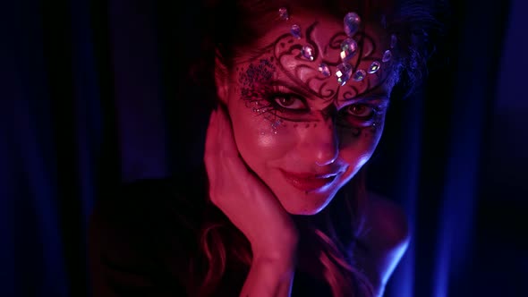 Alluring Lady with Art Makeup Is Flirting with Camera Looking Passionately and Stroking Her Lips alt