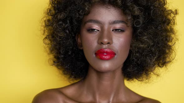 Black Woman with Red Lips Looking at Camera