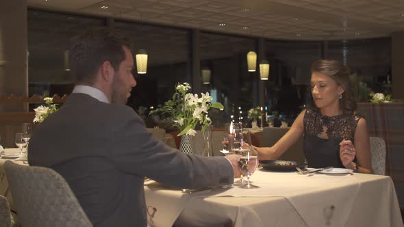 A man and woman couple dining in a luxury restaurant alt