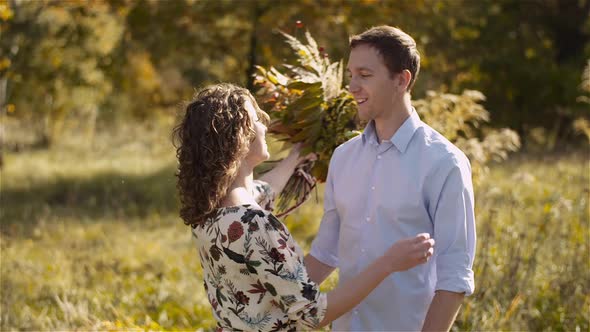 Young Couple in Love Holding Hands Together in Forest alt