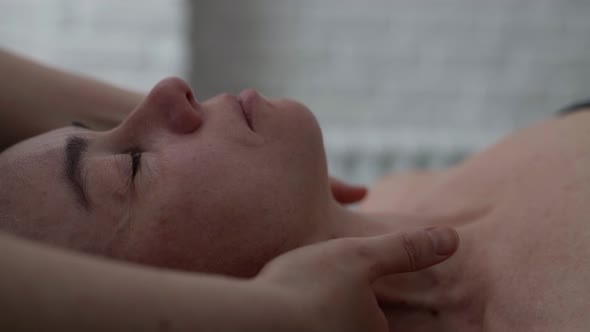 Osteopathic Physician is Massaging Neck of Adult Woman Lying on Massage Table in Clinic of Manual alt