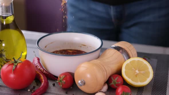 Preparing a Marinade Sauce for Bbq in a Domestic Kitchen  Adding Salt and Spices alt