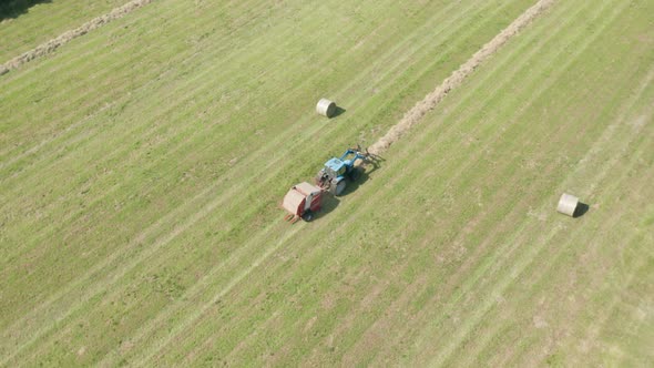 Blue Tractor Hay Bales Aerial View