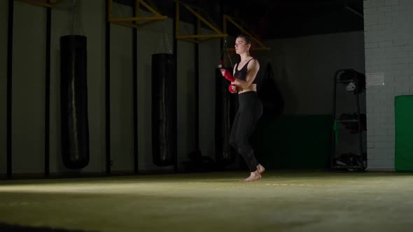 Concentration Kickboxing and Coordination Training Young Female Fighter Jumps on a Rope Strength Fit alt