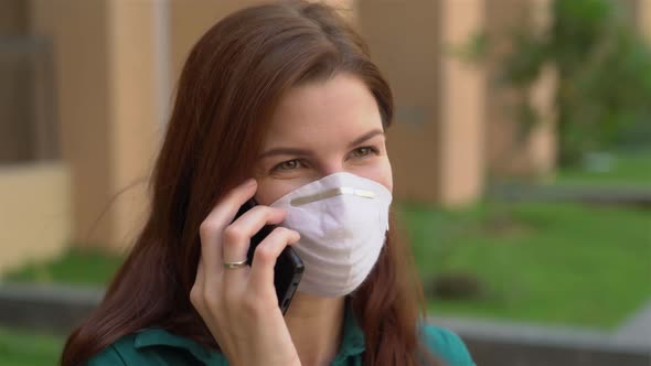 Girl in a Medical Mask Talking on the Phone