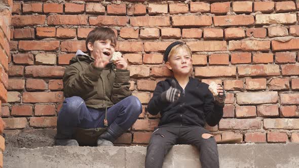 Poor Street Kids Enjoy Meal on Street Eating Donationa Food Sitting Together in Dirty Clothes alt