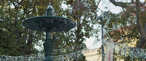 Old decorative fountain in a city park alt