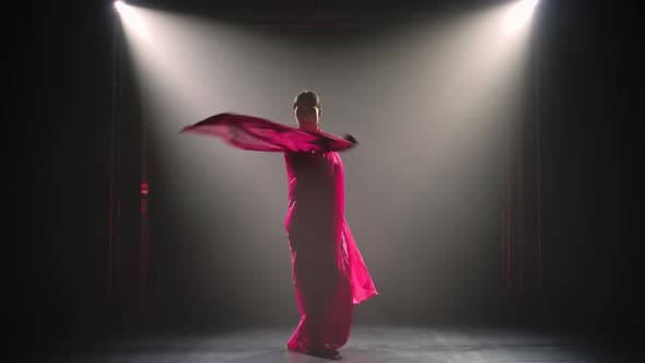 Silhouette a Young Girl Dancer in a Red Sari, Indian Folk Dance, Shot in a Dark Studio with Smoke alt