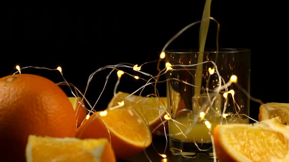 A Slice Of Orange And A Glass With Ice In Which Juice Is Poured With A New Years