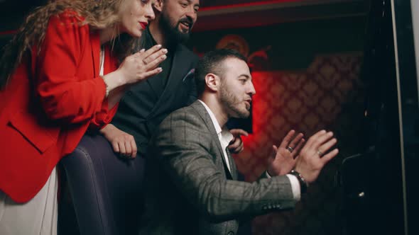 Group of Young People are Rejoice in Victory the Jackpot in a Slot Machine alt