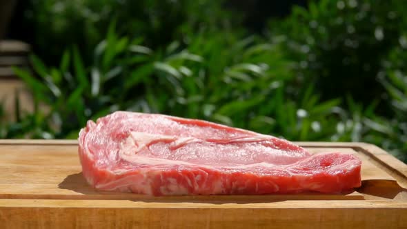 Pork Steak Falls on a Wooden Board alt