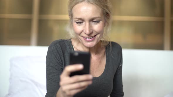 Mature woman texting on her smart phone