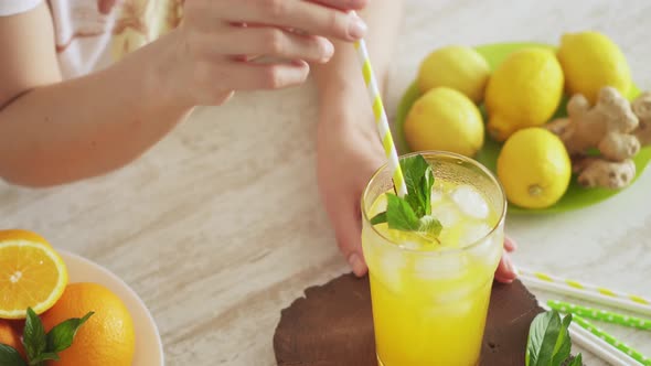 Lemon And Orange Refreshing Drink. Summer Fruit Cocktail In A Tall Glass. Freshly Prepared Lemonade alt