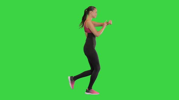 Healthy Sporty Young Woman Running and Using Smart Watch Device on a Green Screen Chroma Key alt