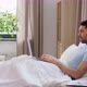 Man with Laptop in Bed at Home Bedroom - VideoHive Item for Sale
