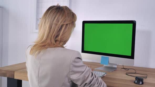 Businesswoman Works on Desktop alt