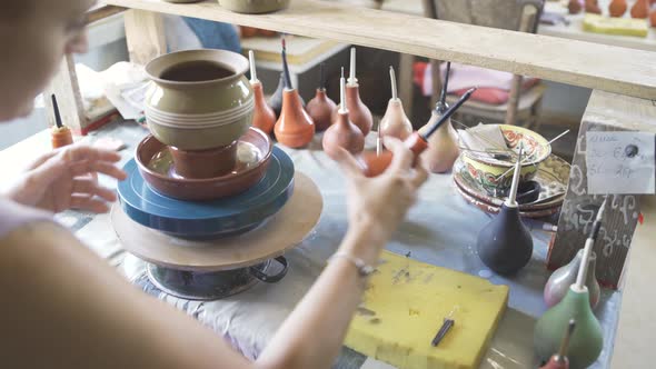 Female Potter Using Precision Applicator for Pottery Glazing and Painting alt