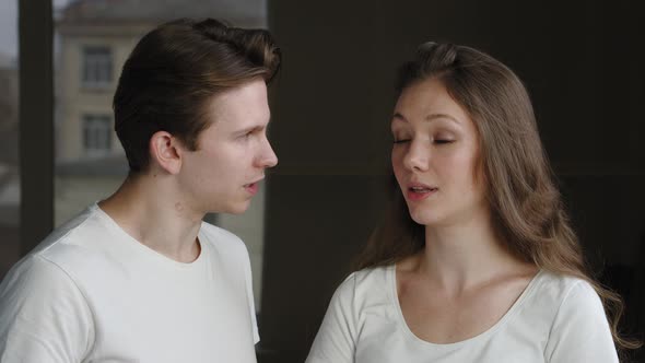 Portrait of Couple of Newlyweds Husband and Wife Quarreling at Home Man Aggressively Speaks to alt