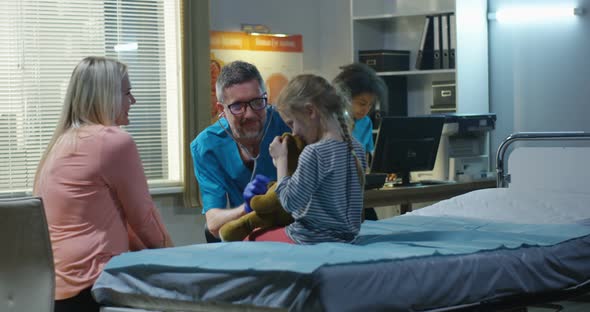 Friendly Doctor Examining Teddy Bear with Stethoscope alt