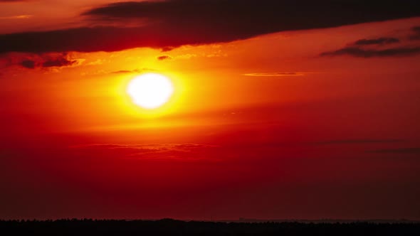 Timelapse Dramatic Sunset with Sun Rays in the Sky Through Orange Layered Clouds alt