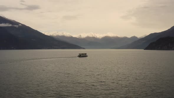 Aerial view of single ferry boat crossing Lago di Como, Cadenabbia, Italy. alt
