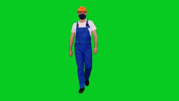 Foreman In Mask And Blue Uniform With Red Hardhat Walking on Green Screen