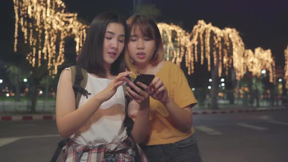 Young student women using mobile looking on map find landmark.