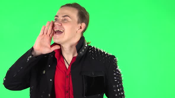 Guy Screams Calling Someone on a Green Screen at Studio. Green Screen alt