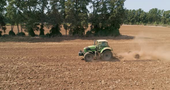 Aerial view of a tractor ploughing an empty field, Kibbutz saar, Israel. alt