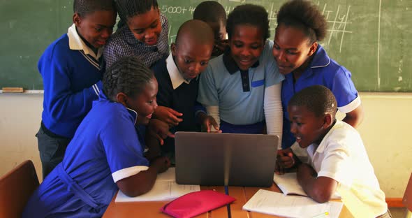 Schoolchildren with laptop in a lesson at a township school alt