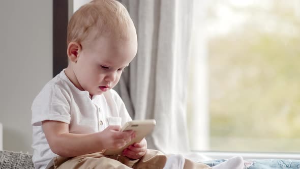 Adorable Baby Boy Learning New Gadget