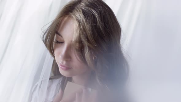 Woman Opening Envelope in Morning alt