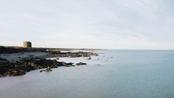 The beautiful rocky shore in Balbriggan with a few of people walking around. The water was very calm alt