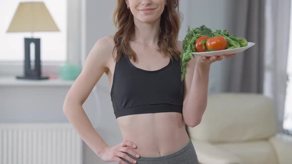 Unrecognizable Confident Slim Woman Holding Plate with Healthful Organic Vegetables Smiling alt