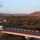Drone Follows Camper Van Rv From the Side It Sunset on Road in Wilderness - VideoHive Item for Sale