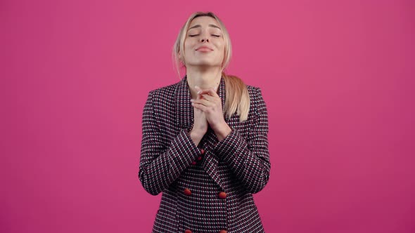 Concentrated Young Woman Who Keeps Her Fingers Crossed and Makes a Wish alt