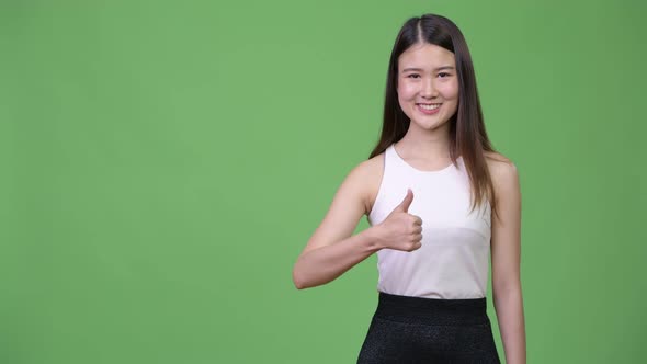 Young Beautiful Asian Businesswoman Giving Thumbs Up