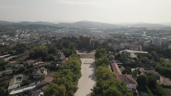 Aerial pullback from Guimaraes Castle revealing cityscape north Portugal, Ascending