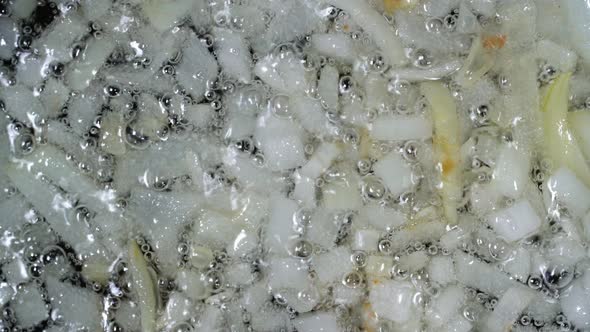 Top View of Finely Chopped Onion Fried in Cooking Oil in Frying Pan