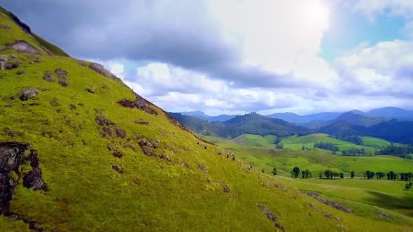 The group walking on the mountain on a cloudy background, hiking drone footage