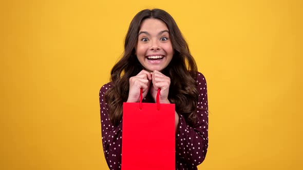 Amazed Teen Girl Taking Pop It Silicone Toy From Shopping Bag Present Pop It alt