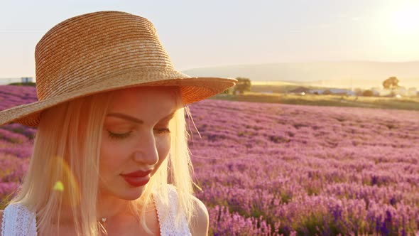 Portrait of a Blonde Woman with Hat in Lavender Fields on Summer